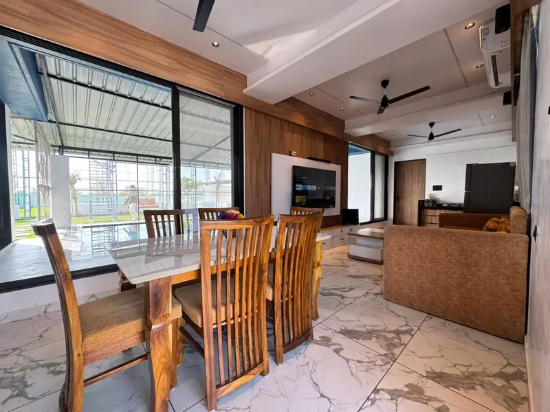 Wooden dining table for eight beside the air conditioned living area