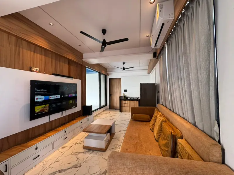 Air conditioned living room with large smart TV and wooden panelling